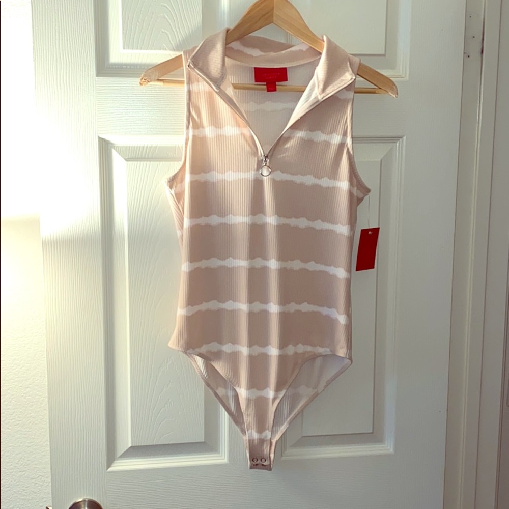 Jennifer Lopez tan and white striped body suit.